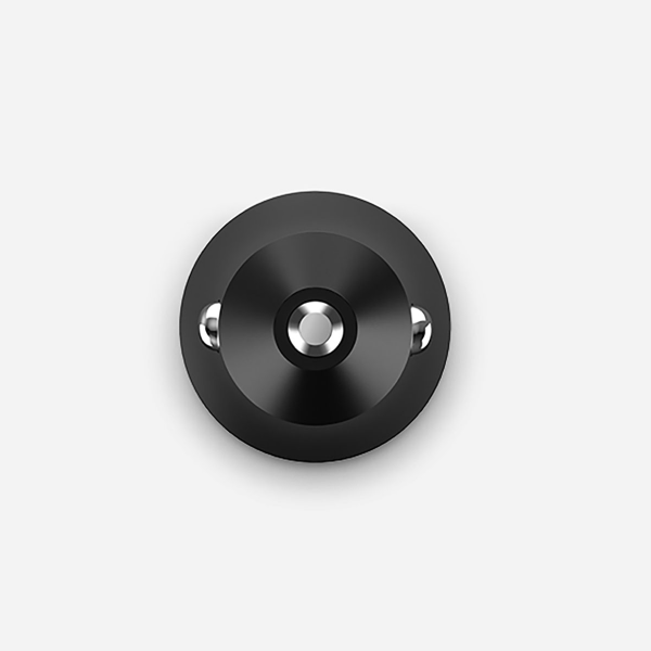 A circular black wall hook with a brushed metal center and two small silver side studs, shown against a light gray background.