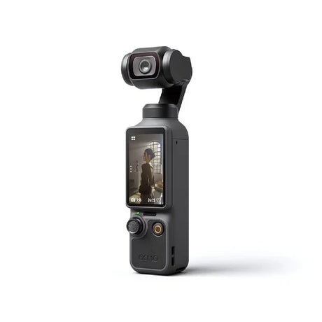 A handheld gimbal camera in dark gray/black with a rear LCD screen showing a video call, photographed on a clean white background.