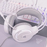 White over-ear gaming headset with a flexible microphone, shown resting on a desk in front of a white mechanical keyboard with RGB backlighting.