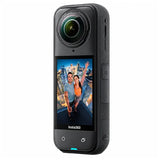 Black 360-degree camera with a display showing a couple in an urban setting, on a white background.
