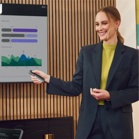 Presenter holding Logitech Spotlight 2 during a presentation