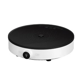 Round black and white electronic device on a white background
