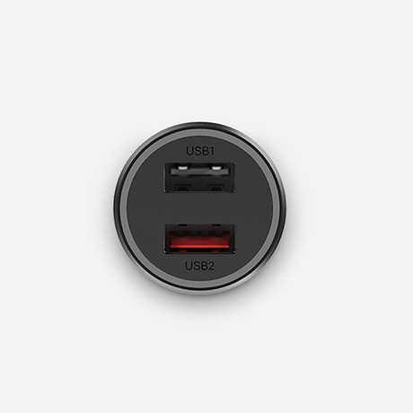 A round black dual USB-C car charger with one standard USB-A style port labeled USB1 and one USB-C style port labeled USB2, both with red accents, shown on a light gray background.