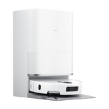 A white robotic vacuum cleaner docked inside a matching white charging station, shown on a clean white background. The product features a minimalist design with a small silver metallic accent band and a dark gray mat extending from the base.