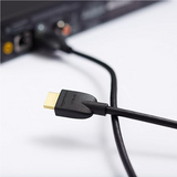 HDMI cable being plugged into a device with a white background
