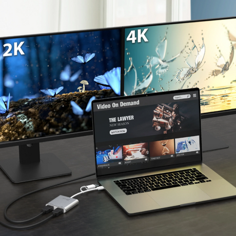 Laptop displaying a video on demand platform with two monitors showing 2K and 4K content.