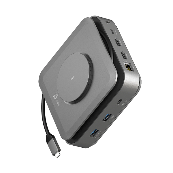A compact 15-inch portable desktop computer in dark gray aluminum, shown at an angle to display its ports and attached power cable on a solid white background.