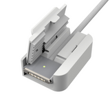 Close-up of a gray electronic device with a cable on a white background