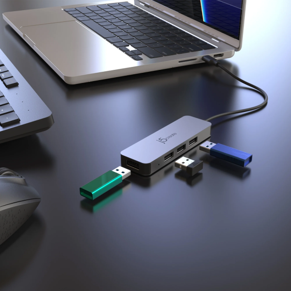 USB hub connected to a laptop on a dark surface