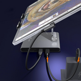Laptop with a stand and attached monitor on a dark background