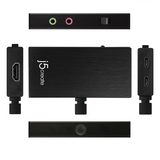 Black J5create video capture adapter kit shown from multiple angles on a white background, including the main metal-look box, HDMI input module, USB-C output module, audio jack module, and front camera bar.