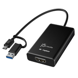 Black 4K capture device with cables on a white background
