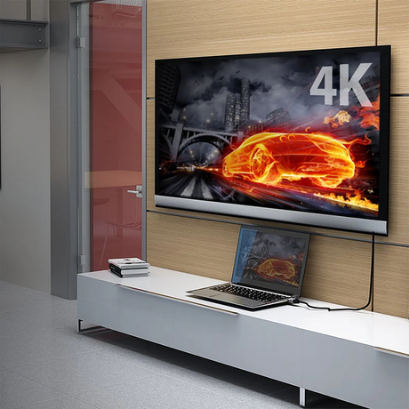 j5create JDC52 Premium High-Speed HDMI®™ Cable with Etherne  (6.6ft) A 6.6 ft (2m) 4K HDMI cable 4K TV displaying a car in flames with a laptop on a stand below.