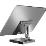 A silver aluminum tablet stand holding an iPad, shown from a rear three-quarter angle on a clean white background.