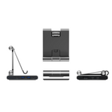A dark gray and silver magnetic charging dock shown from multiple angles on a plain white background, including side views with a charging cable attached.