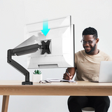 j5create JTSA101 Ergonomic Monitor Mount Person sitting at a desk with a computer setup and a transparent screen protector.
