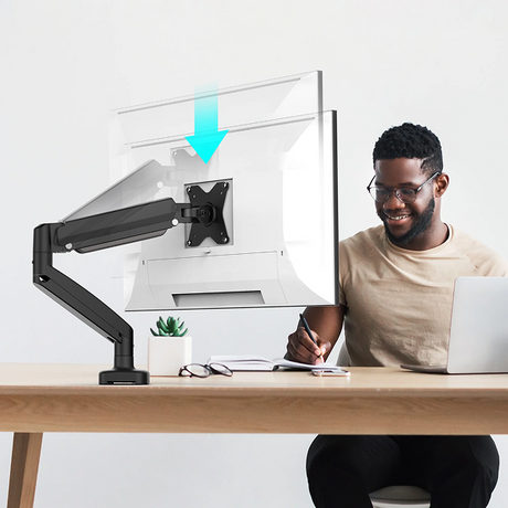 j5create JTSA101 Ergonomic Monitor Mount Person sitting at a desk with a computer setup and a transparent screen protector.